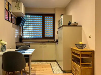 a kitchen with a table and a refrigerator at Heart of Sofia Apartment in Sofia