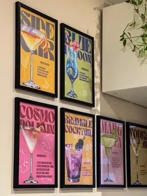a group of posters on a wall with cocktails at Heart of Sofia Apartment in Sofia
