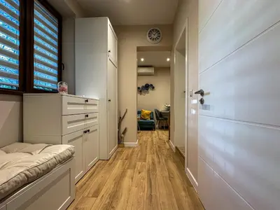 a hallway with a bed and a window and a door at Heart of Sofia Apartment in Sofia
