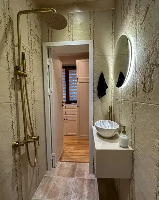 a bathroom with a sink and a mirror at Heart of Sofia Apartment in Sofia