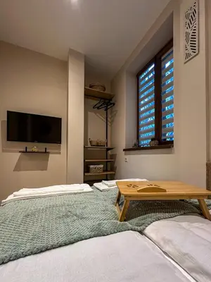 a living room with two beds and a table at Heart of Sofia Apartment in Sofia