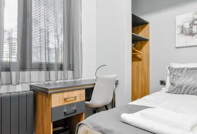 a bedroom with a desk and a bed at Stylish 2-Bedroom Sofia Stay in Sofia