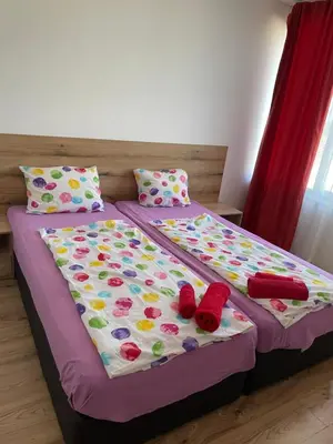 a bed with two pillows and red shoes on it at Casa De Zambini in Plovdiv