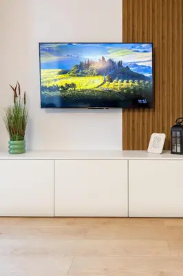 a television on top of a white cabinet at Evergreen 301 - Luxury ski apartment near gondola in Bansko