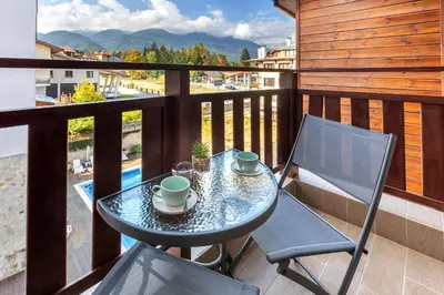 a table and chairs on a balcony with a view at Evergreen 301 - Luxury ski apartment near gondola in Bansko
