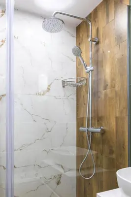 a bathroom with a shower with marble walls at Evergreen 301 - Luxury ski apartment near gondola in Bansko