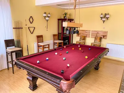 a room with a pool table with balls on it at Villa Madera - Spacious House with Swimming Pool, Sauna and Pool Table in Saparewo