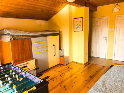 a room with a bed and a pool table at Villa Madera - Spacious House with Swimming Pool, Sauna and Pool Table in Saparewo