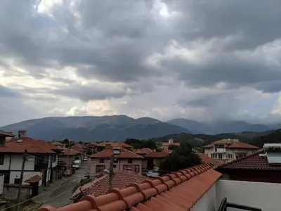 a view of a town with mountains in the background at Къща за гости Семейство Петрови in Kalofer