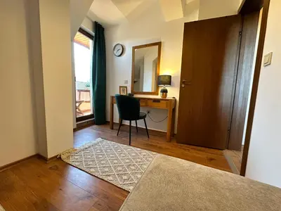 a room with a desk and a chair and a table at Murphys Lodge panorama apartment in Bansko