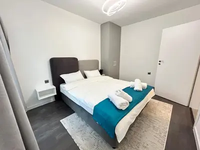 a bedroom with a bed with towels on it at Diamond Apartment in Plovdiv