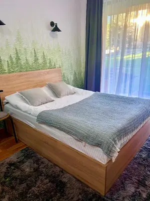 a bed sitting in a bedroom with a window at Flat F6 Bansko Rentals in Bansko