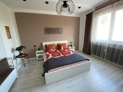 a bedroom with a bed and a large window at Apartment PS in Sofia