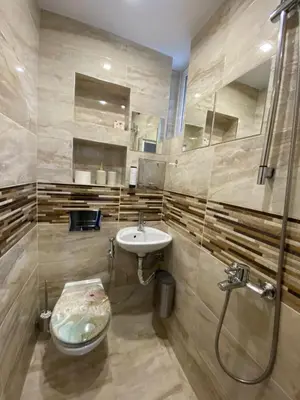 a bathroom with a sink and a shower and a toilet at Apartment PS in Sofia