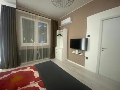 a room with a bedroom with a tv and a window at Apartment PS in Sofia
