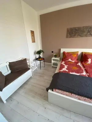 a bedroom with a bed and a couch at Apartment PS in Sofia