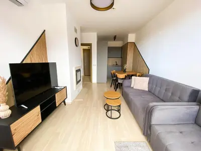 a living room with a couch and a table at ELDORA Deluxe Private Apartment in Bansko