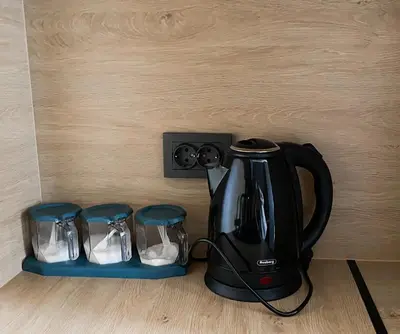a black coffee maker and two stools next to a wall at ELDORA Deluxe Private Apartment in Bansko