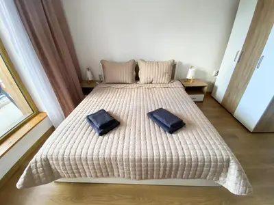 a bedroom with a bed with two pillows on it at ELDORA Deluxe Private Apartment in Bansko