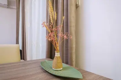 a vase with flowers in it sitting on a table at Comfort 1 Bedroom App in Plovdiv