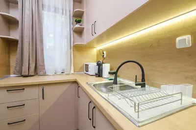 a kitchen counter with a sink and a window at Comfort 1 Bedroom App in Plovdiv