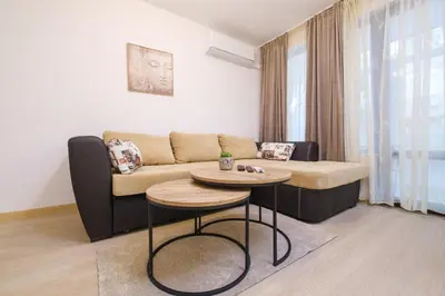 a living room with a couch and a table at Comfort 1 Bedroom App in Plovdiv