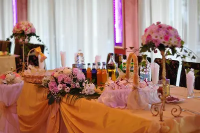 a table with flowers and wine bottles on it at Hotel Paradise in Ognyanovo