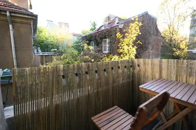a wooden fence with a wooden table and a bench at Cozy Central Apartment By NDK and Vitosha Blvd with Free secured parking and two terraces in Sofia