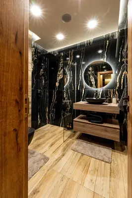 a bathroom with a sink and a mirror at Beni Deluxe in Plovdiv