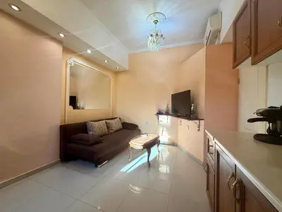 a living room with a couch and a table at Prime Center - 1BDR Apt - Top Floor Next to the National Stadium & Sofia University in Sofia