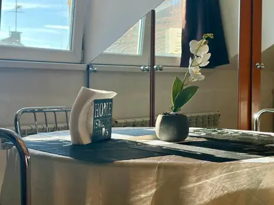 a table with a book and a potted plant on it at Prime Center - 1BDR Apt - Top Floor Next to the National Stadium & Sofia University in Sofia