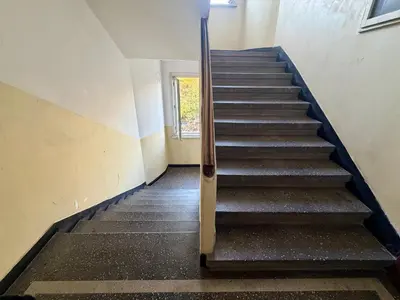 a staircase in an empty building with a stair case at Prime Center - 1BDR Apt - Top Floor Next to the National Stadium & Sofia University in Sofia