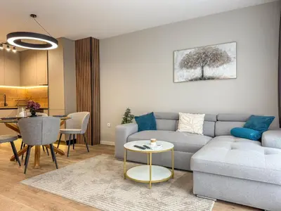 a living room with a couch and a table at 2BR Apartment in a Modern Complex with free Street Parking in Plovdiv