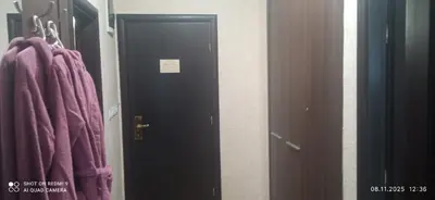 a black door in a room with purple towels at СПА апартамент 