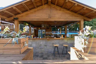 an outdoor bar with two stools in front of it at СПА апартамент 