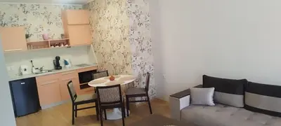 a small living room with a table and a couch at СПА апартамент 