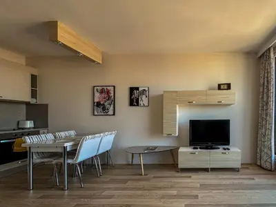 a living room with a table and a television at Quiet & Comfortable Urban Retreat in Sofia