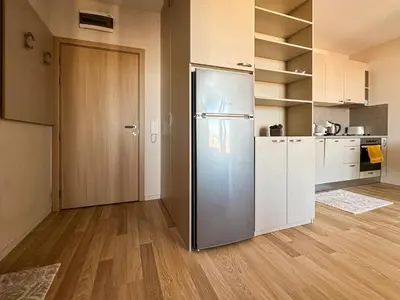 a kitchen with a stainless steel refrigerator in a room at Quiet & Comfortable Urban Retreat in Sofia