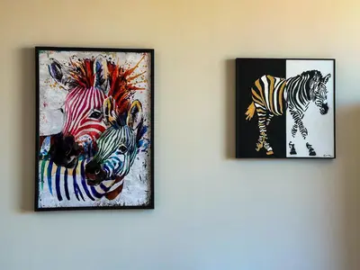 two framed pictures of zebras on a wall at Quiet & Comfortable Urban Retreat in Sofia