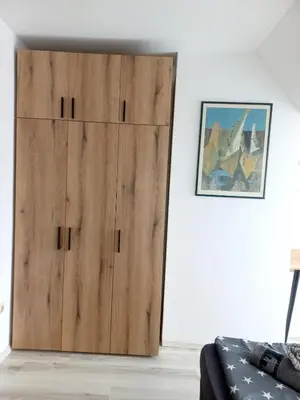 a large wooden door in a room with a couch at Cozy apartment Alba with two bedrooms! in Blagoevgrad