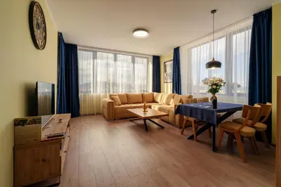 a living room with a couch and a table at Rila Sunshine Apartment in Samokov