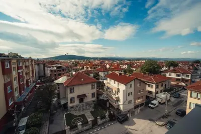 an aerial view of a city with buildings at Rila Sunshine Apartment in Samokov