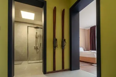 a bathroom with a shower and a glass door at Rila Sunshine Apartment in Samokov