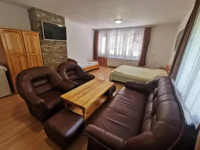 a living room with a couch and a table at Къща за гости 