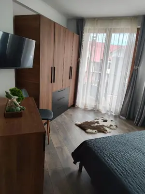 a bedroom with a bed and a desk and a television at The Monastery 3 1B9-Mанастира 3 1Б9 in Pamporovo