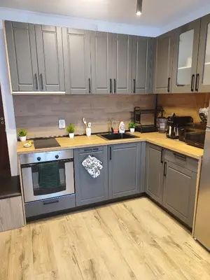a kitchen with gray cabinets and a stove top oven at The Monastery 3 1B9-Mанастира 3 1Б9 in Pamporovo