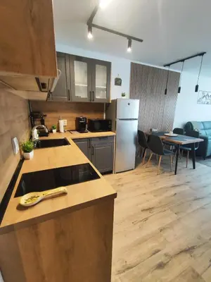a kitchen with wooden counter tops and a table with chairs at The Monastery 3 1B9-Mанастира 3 1Б9 in Pamporovo