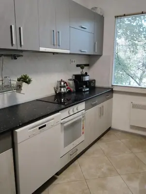 a kitchen with white appliances and a window at Apartment With Free Parking - Center Plovdiv in Plovdiv