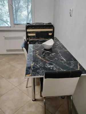 a dining room table with a black marble top at Apartment With Free Parking - Center Plovdiv in Plovdiv
