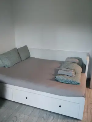a white bed with pillows and towels on it at Apartment With Free Parking - Center Plovdiv in Plovdiv